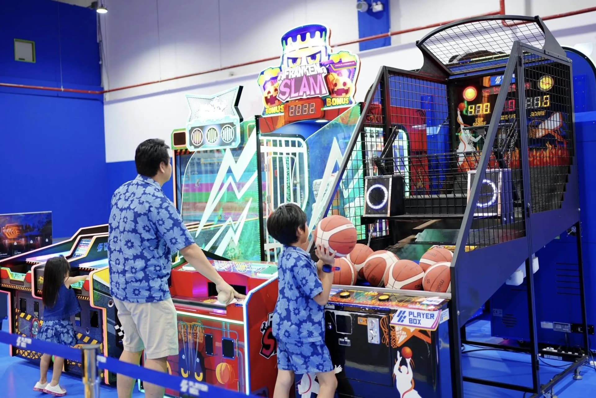 Father and child shooting hoops at the basketball arcade row, The Mall Bangkae Playerbox