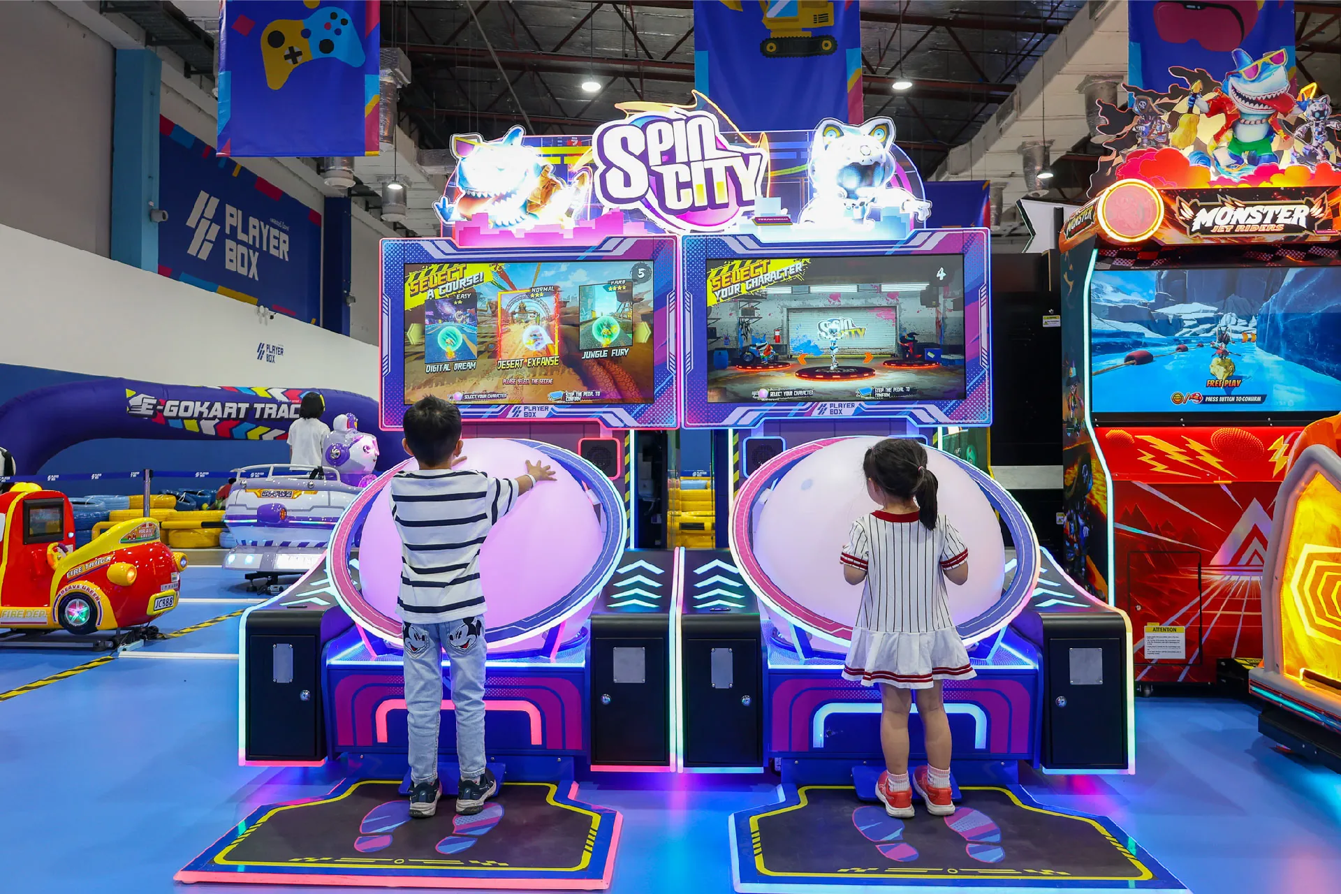 Two kids playing the Spin City roller ball game at The Mall Bangkae Playerbox