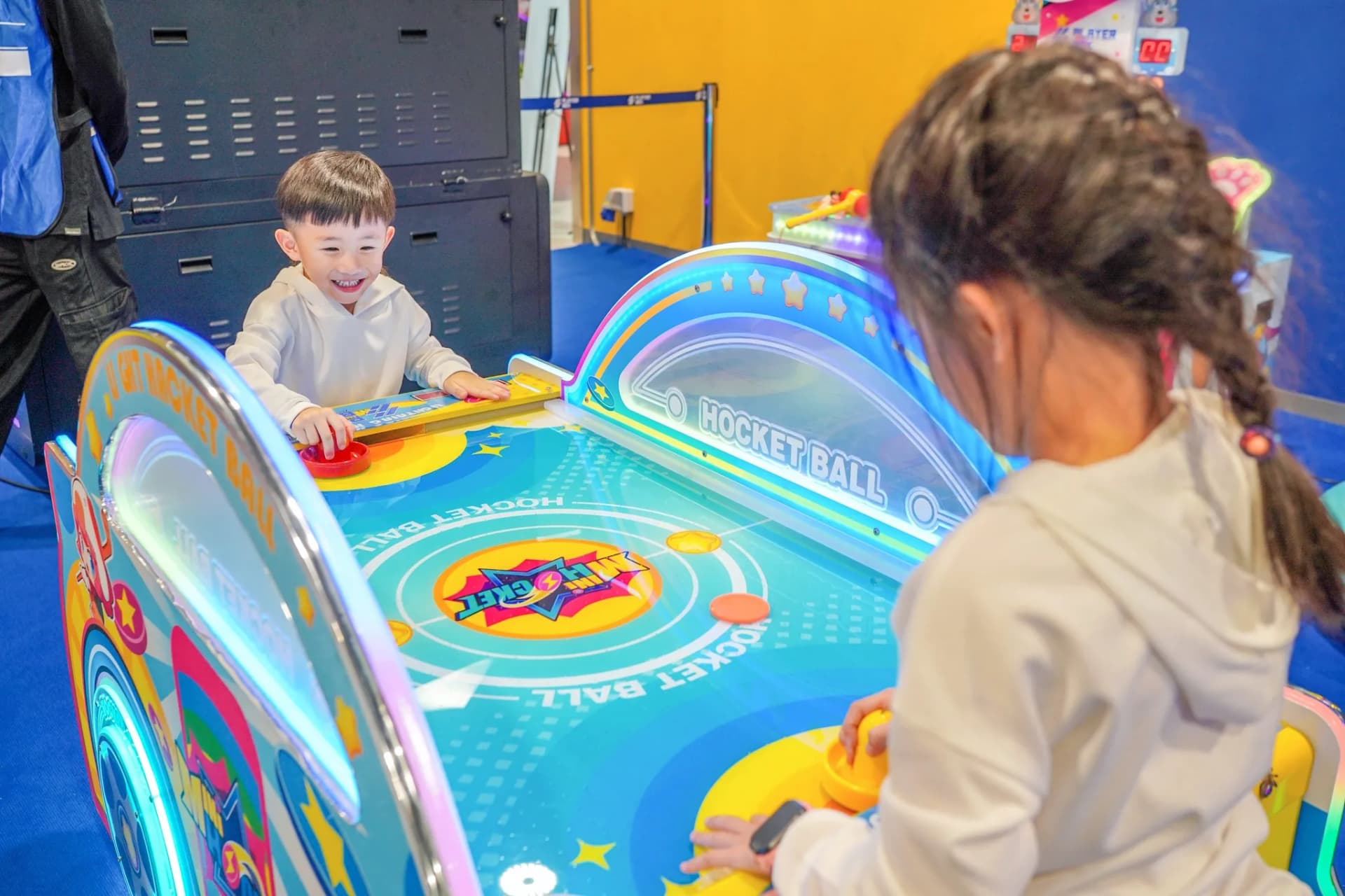 Two children playing Rocket Ball air hockey at Central Rama 3 Playerbox