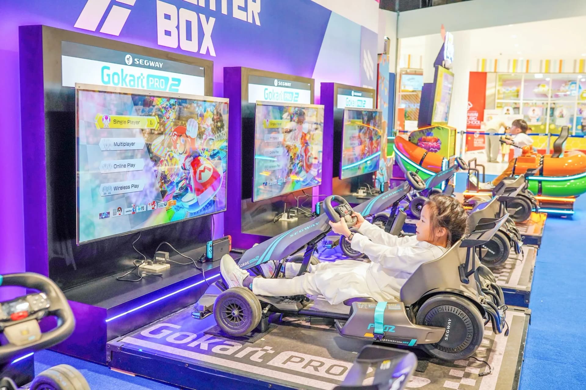 Kid driving a GoKart Pro racing simulator at Central Rama 3 Playerbox