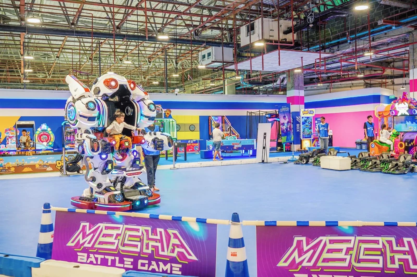 Kids riding the Robot Rider around the arena at Central Rama 3