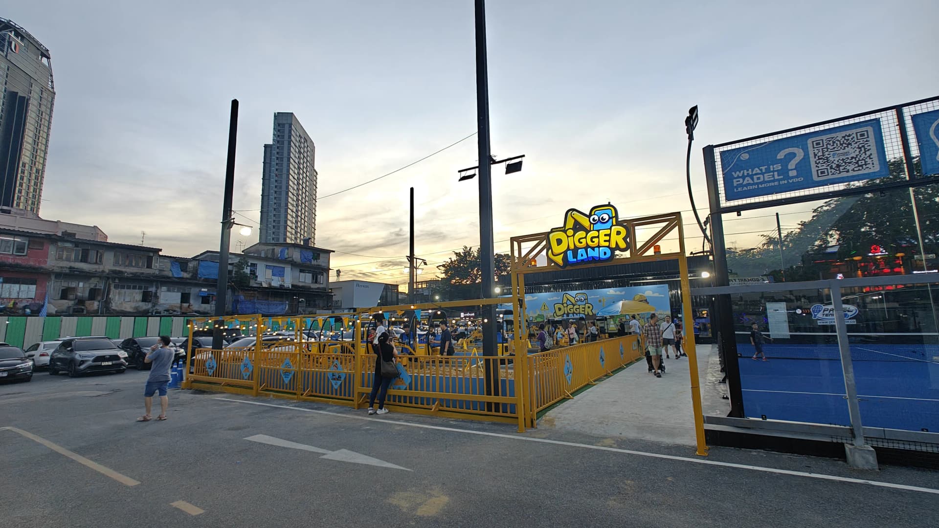 Diggerland entrance gate at Chula 28 at dusk with Padel courts visible