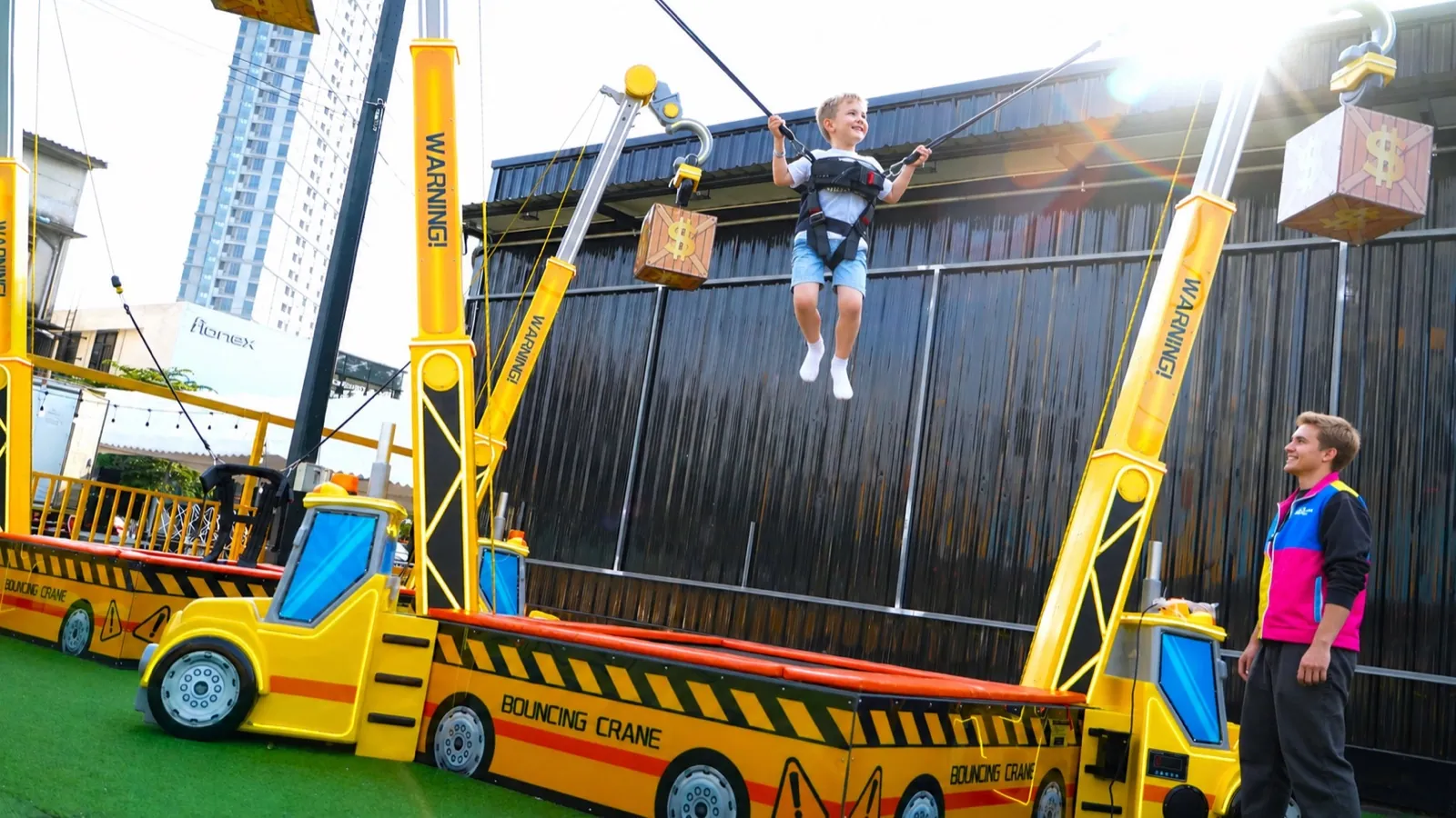Kid mid-bounce on the Sky Jumper bungee rig at Chula 28