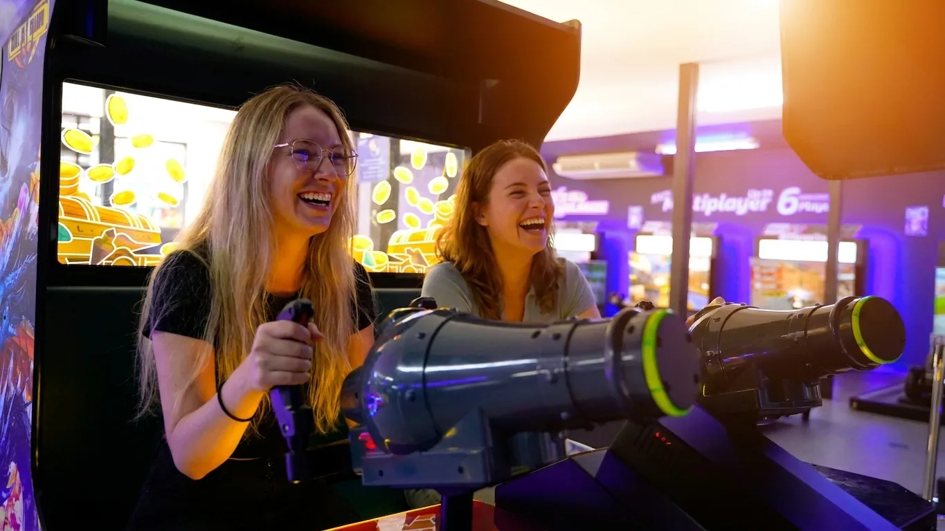 Friends playing an arcade shooter at Playerbox ICONSIAM