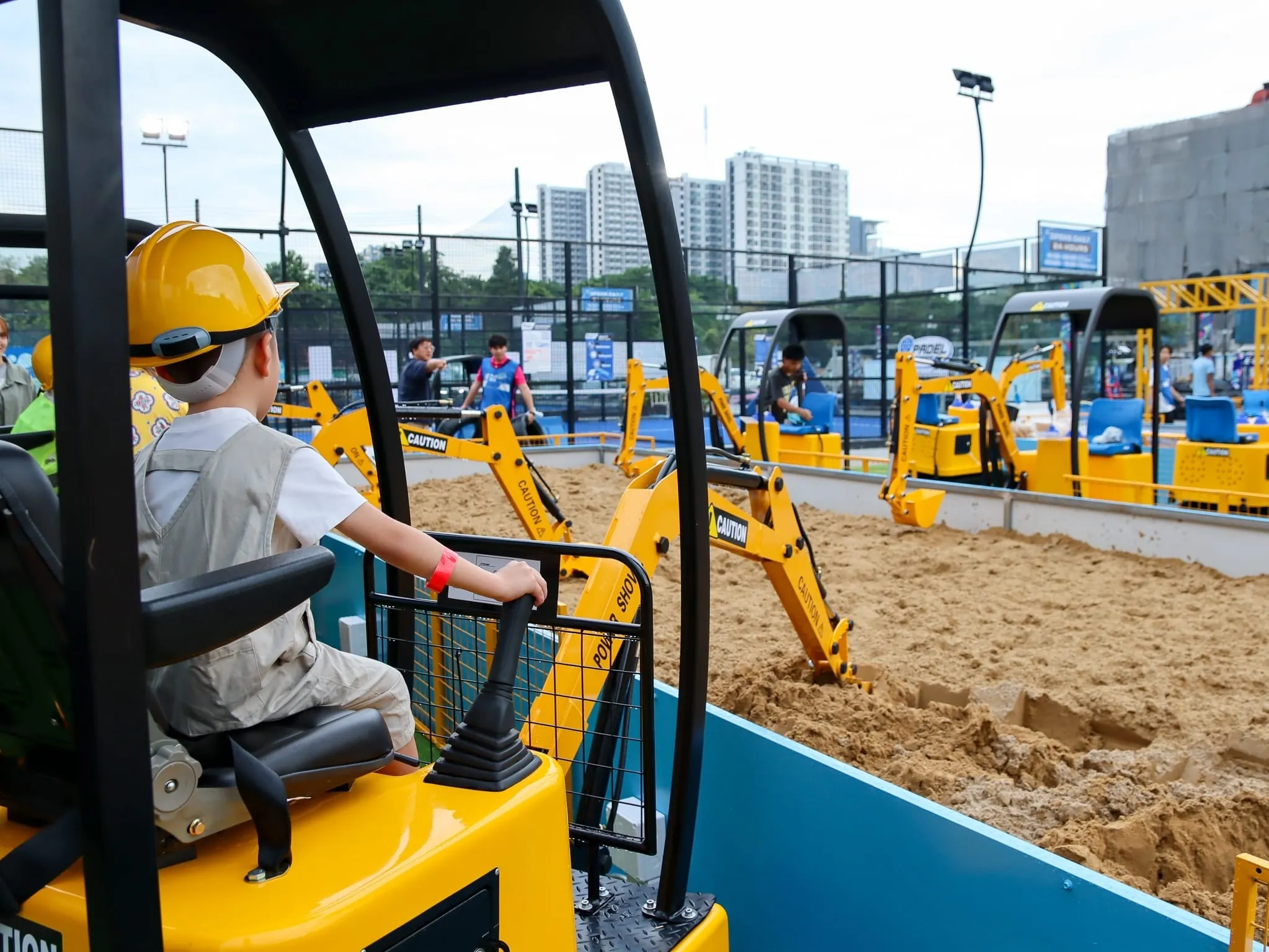 Multiple Diggerland excavators operating at outdoor pit in Phuket
