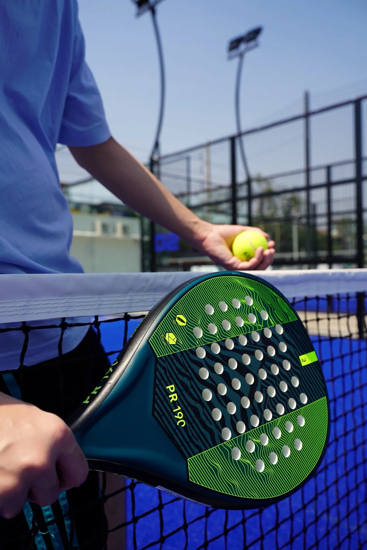 Padel racquet, ball and glass-back court at Chula 28