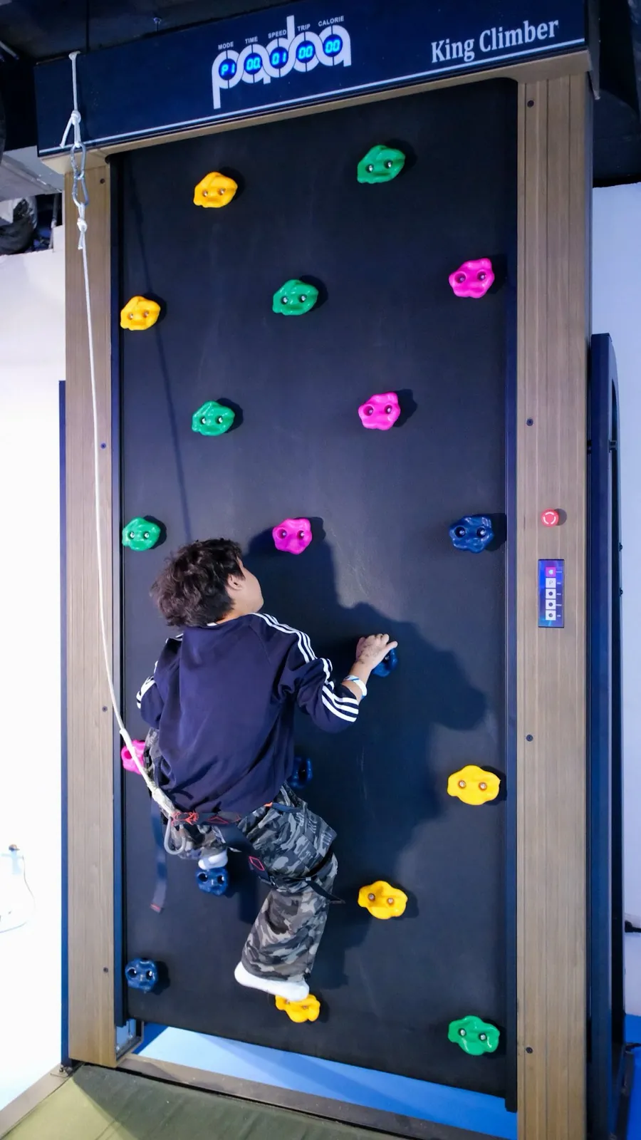 A child climbing the King Climber arcade wall at Siam Discovery